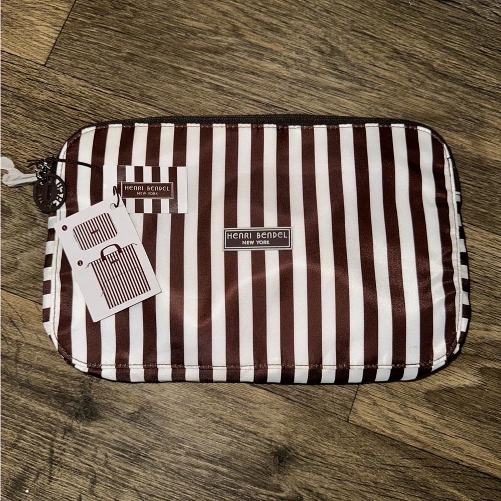 Henri Bendel zip around packable backpack. Signature brown and white stripes
